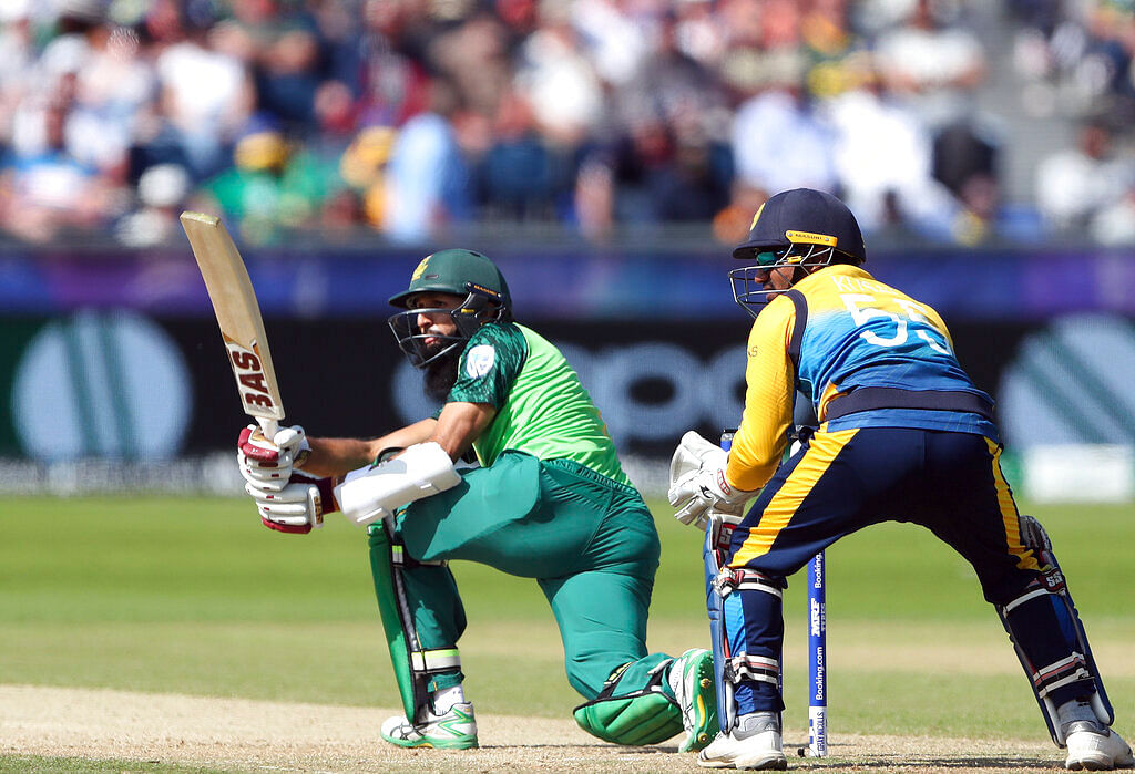 South Africa's batsman Hashim Amla, left, watches his shot.