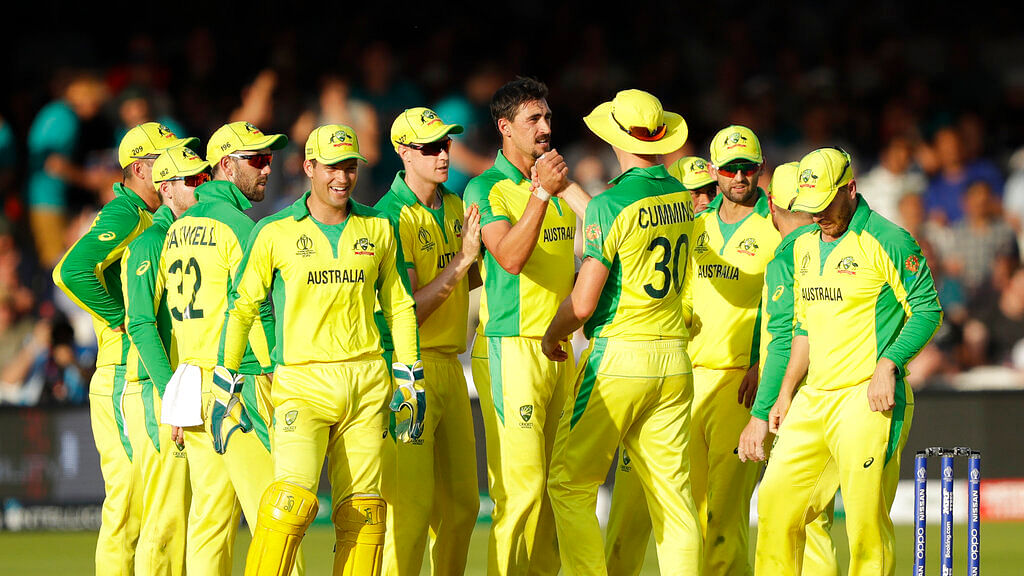 Australia's Mitchell Starc, centre, celebrates with his teammates after taking the wicket of New Zealand's captain Kane Williamson.