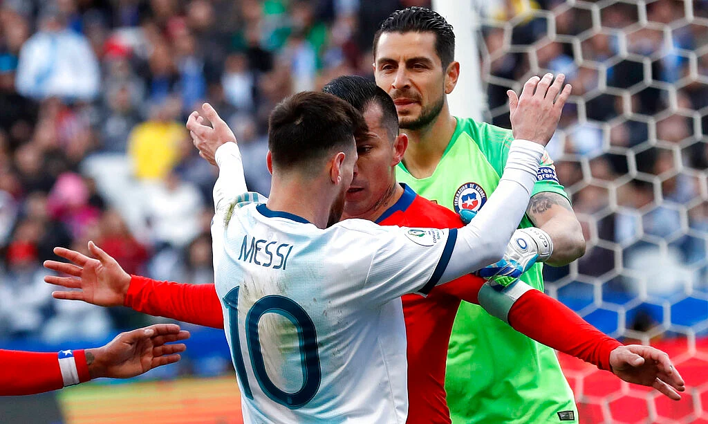 Argentina's Lionel Messi, left, and Chile's Gary Medel argue during Copa America third-place soccer match at the Arena Corinthians in Sao Paulo.