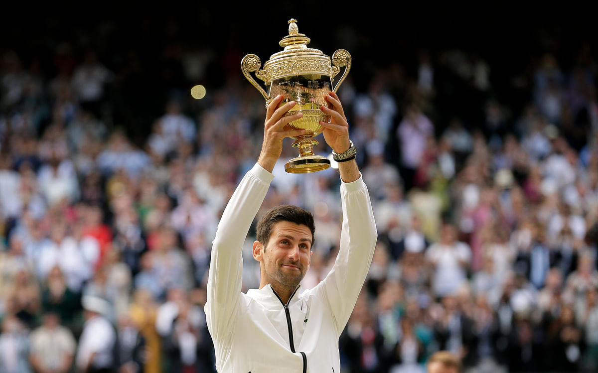 Novak Djokovic lifting the wimbledon trophy