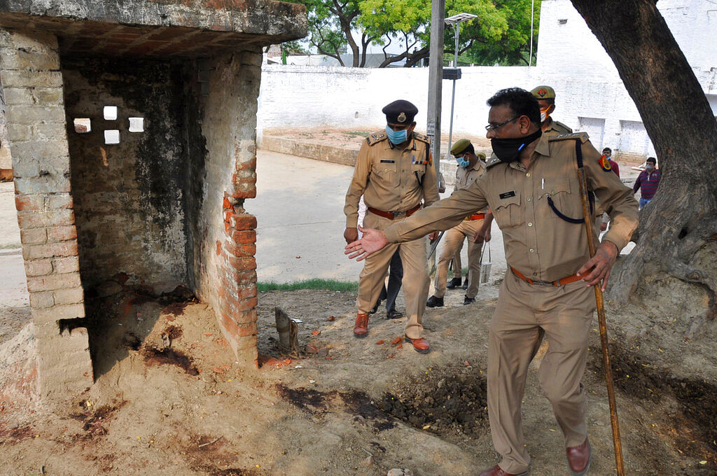 Policemen inspect the scene of an ambush in Kanpur, India, Friday, July 3, 2020.