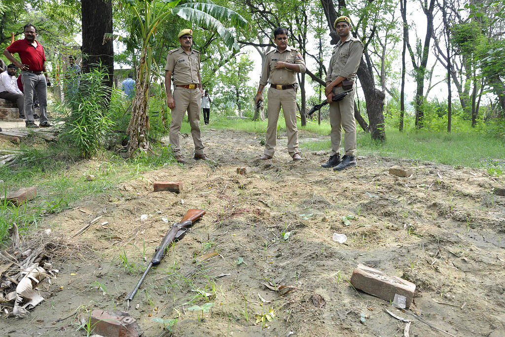 Policemen inspect the scene of an ambush in Kanpur, India, Friday, July 3, 2020.