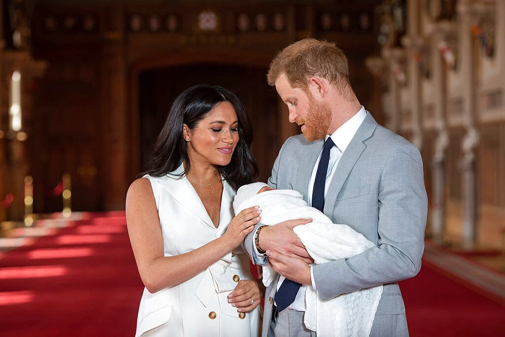 Harry and Meghan holding their son Archie
