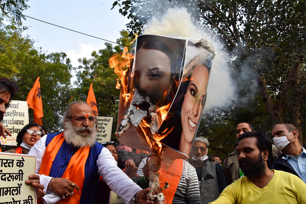 burn portraits of Meena Harris, niece of U.S. Vice President Kamala Harris, and Greta Thunberg in New Delhi, India,