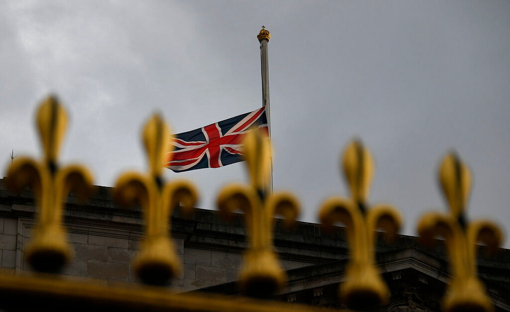 The Union flag waves in the wind at half staff over Buckingham Palace in London, Friday, April 9, 2021.