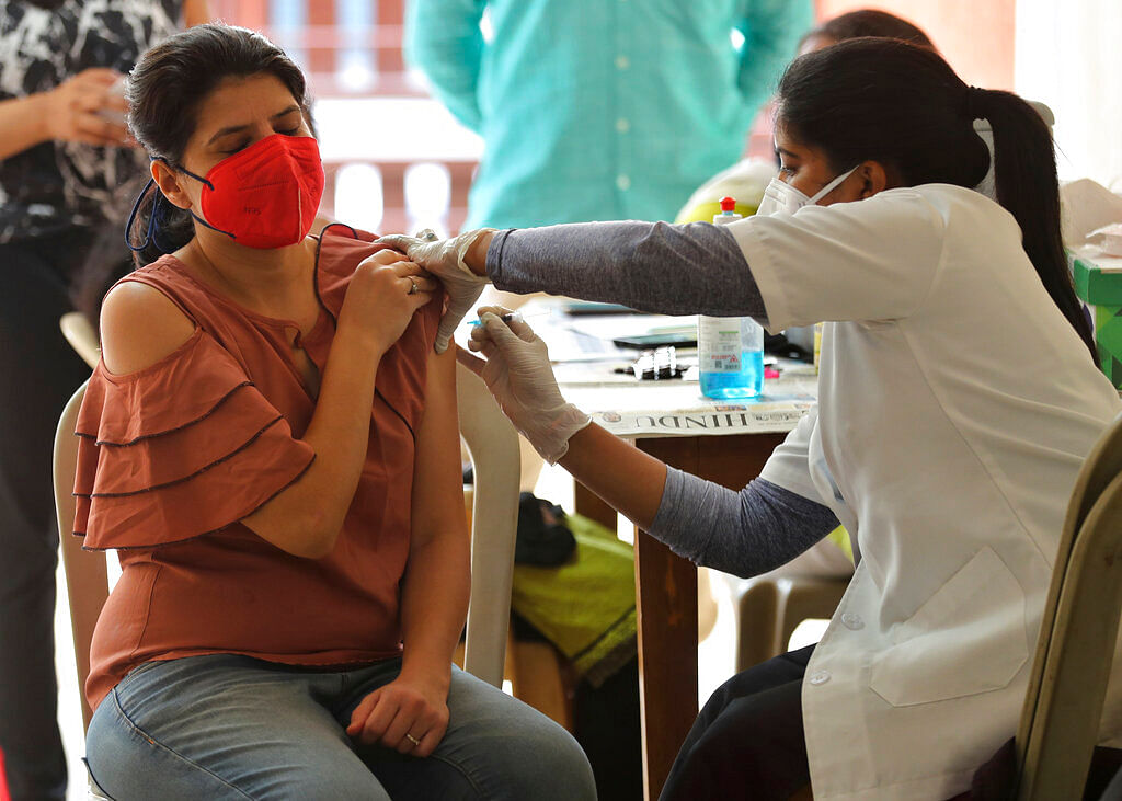 A woman receives the AstraZeneca vaccine