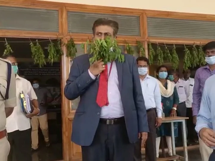 தஞ்சாவூர்: கார் முதல் ஆலோசனைக் கூட்டம் வரை..! - கையில் வேப்பிலைக் கொத்துடன் வந்த அரசு அதிகாரி