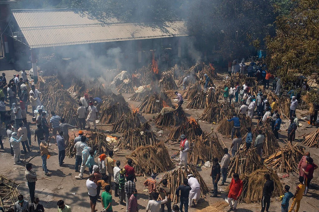 multiple funeral pyres of those who died of COVID-19
