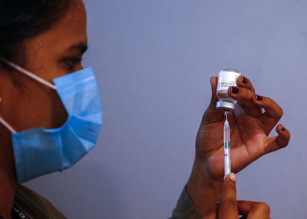A doctor prepares to administer vaccine