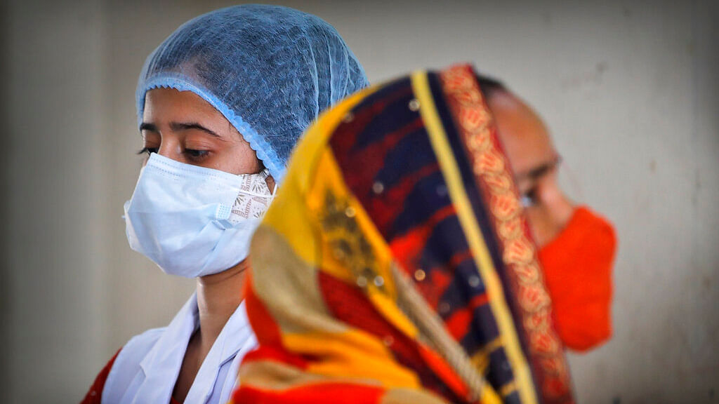 A health worker prepares to administer the vaccine