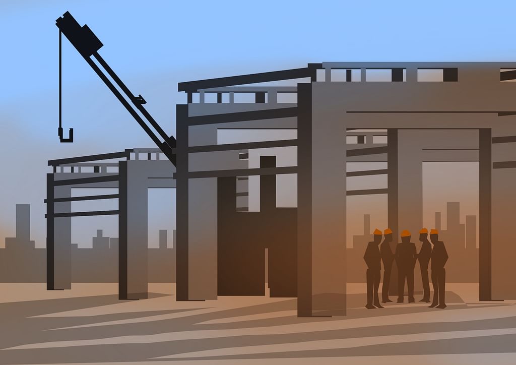 Bharath having a stand-up meeting at the factory construction site with his team