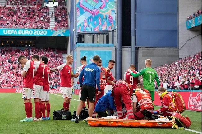 Christian Eriksen being treated on the ground