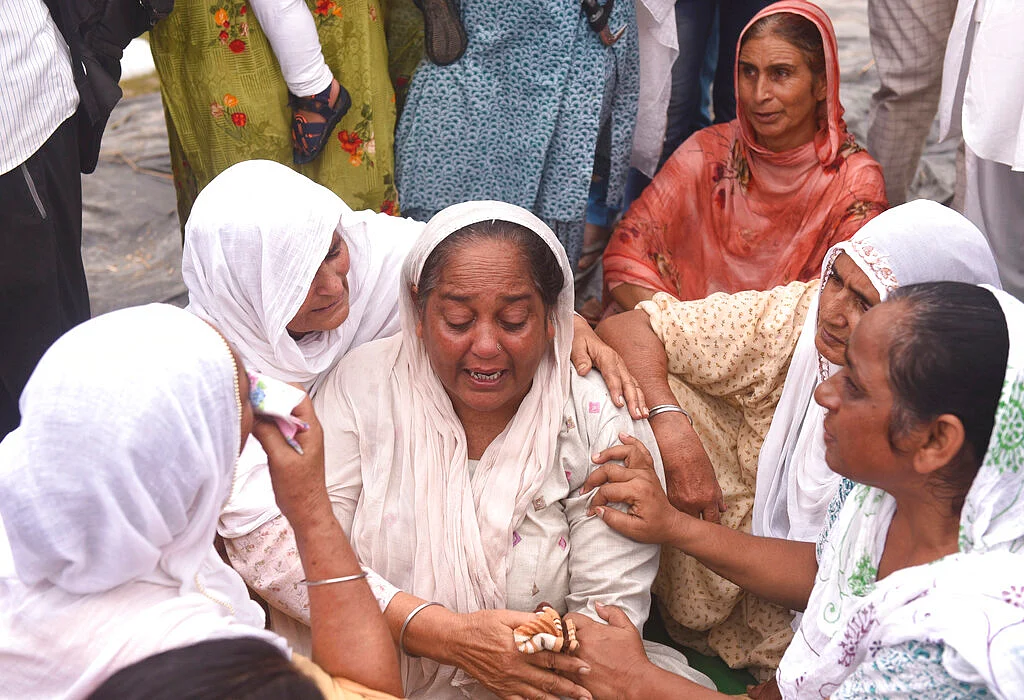 Relatives and neighbors of a farmer who was killed Sunday after being run over by a car owned by India's junior home minister