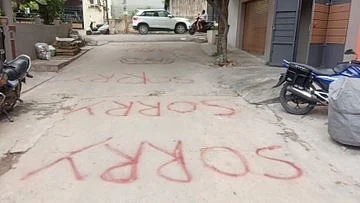 'Sorry' written on the way