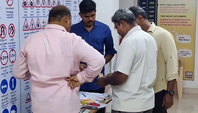 சேகரிக்கப்பட்ட லஞ்சப் பணத்தை எண்ணும் போலீஸார்.