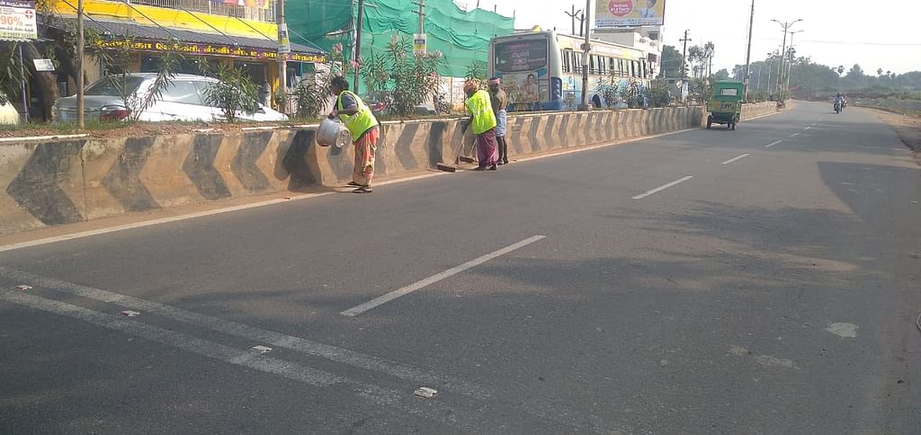 Sanitation workers in highway maintenance work