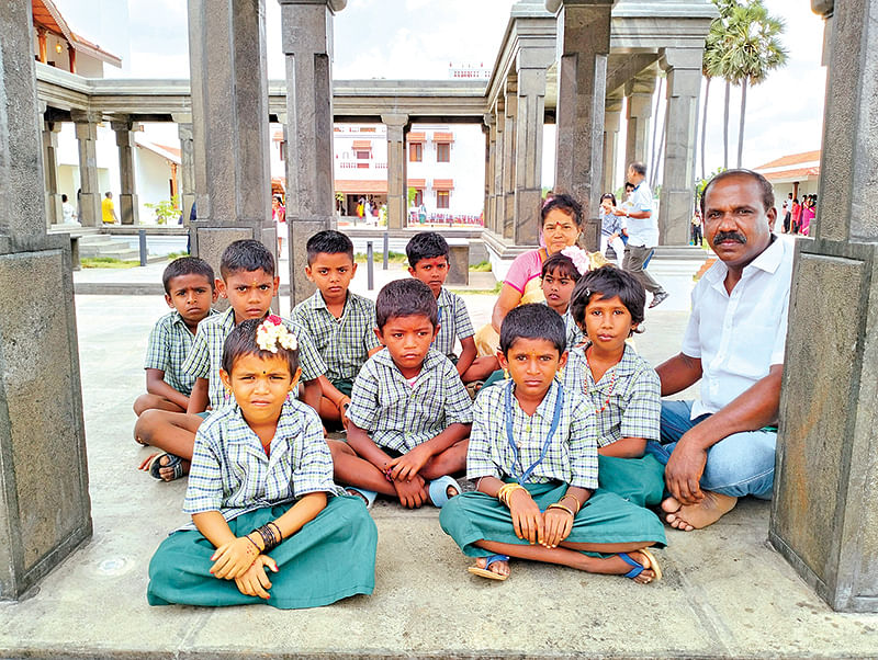 அரசுப்பள்ளி மாணவர்களுடன் ஆசிரியர்கள் அமுதா மற்றும் ஆறுமுகம்