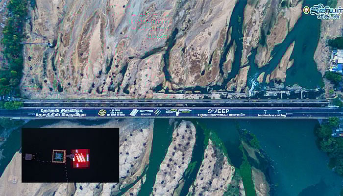 100% வாக்களிப்பை வலியுறுத்தி திருச்சி காவிரி பாலம், தெப்பக்குளத்தில் ஓவியங்கள்- கழுகு பார்வை படங்கள்